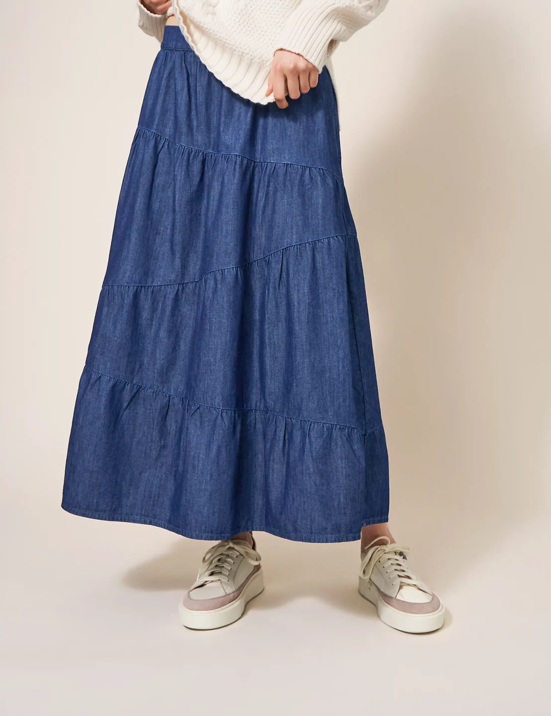 a woman wearing a long denim skirt